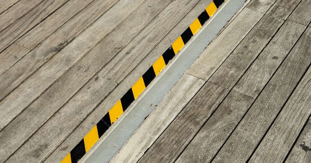 caution tape on wooden walkway
