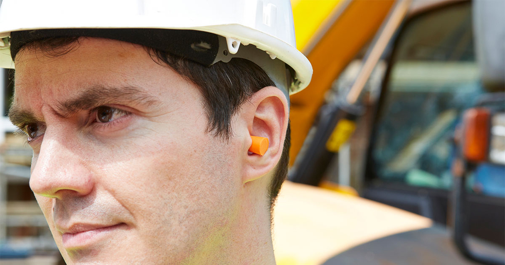 Man wearing protective earplugs