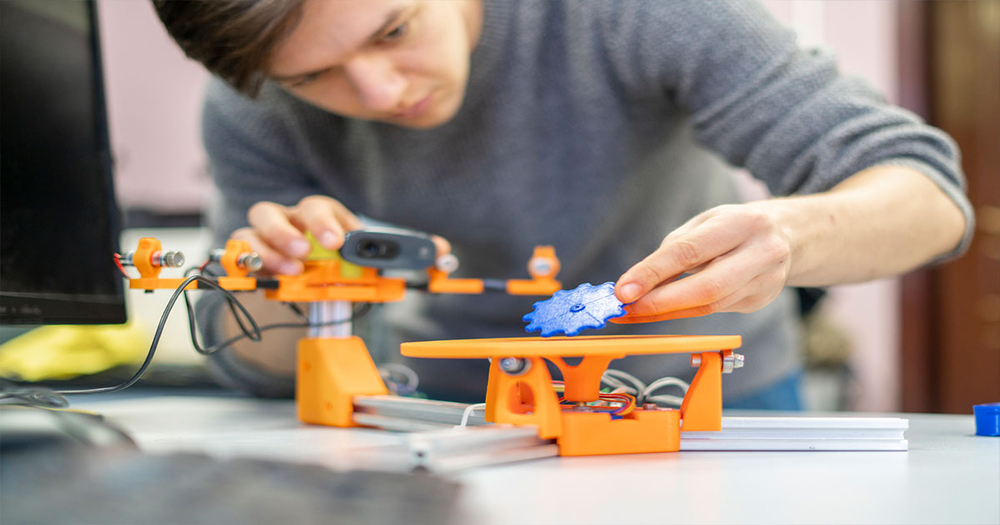 Man building object with 3d printed parts