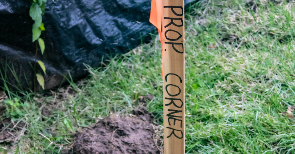 A land survey stake marking the corner of a property.