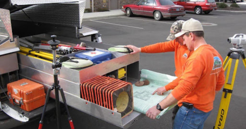 Land surveyor's planning using their organized truck bed.